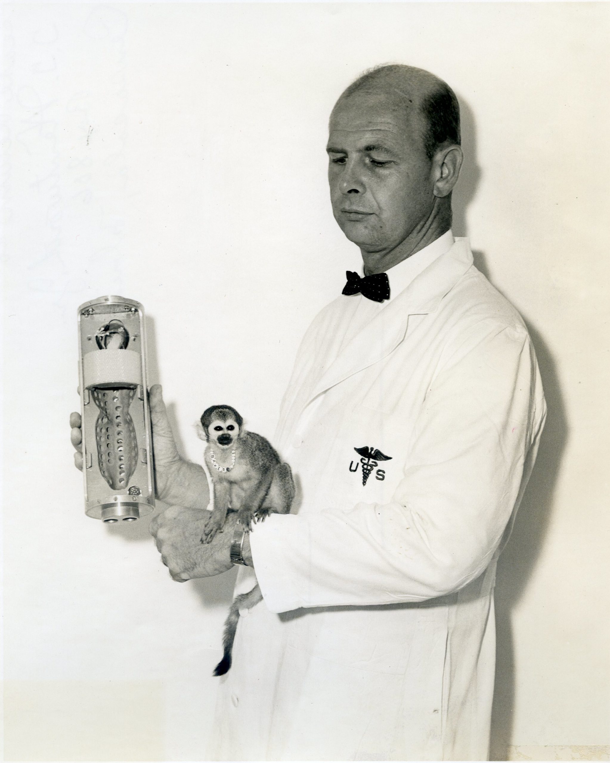 Stulken with Miss Baker-001 Miss Baker Dr. Donald E. Stullken holding space capsule that monkey Baker made her space trip in;